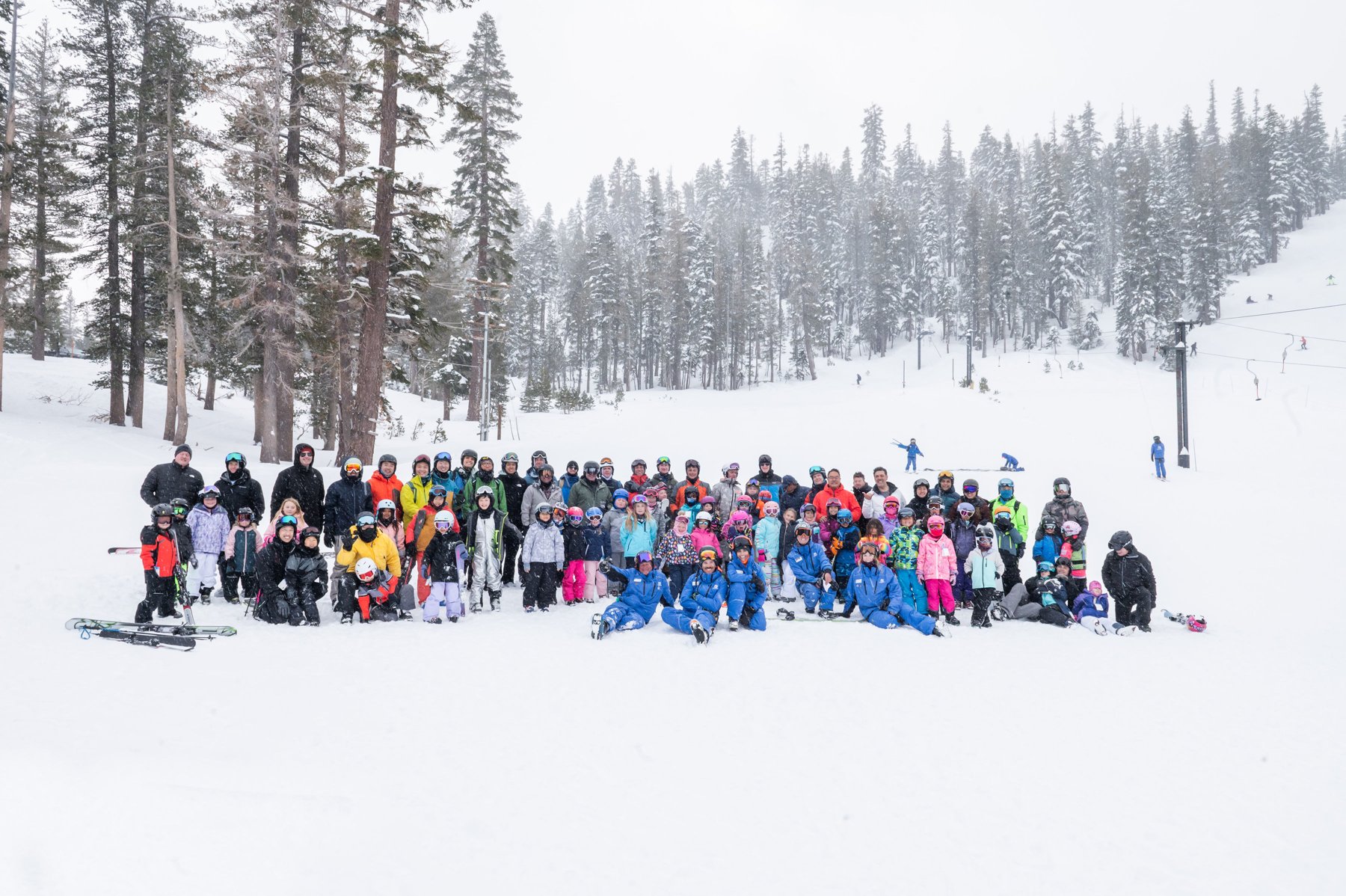 Dads and children gather in falling snow on the 2024 Mammoth trip